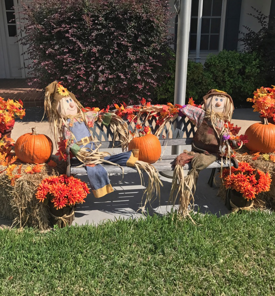 Scarecrows with pumpkins