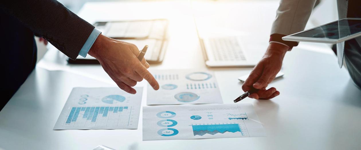 two men reviewing data graphs